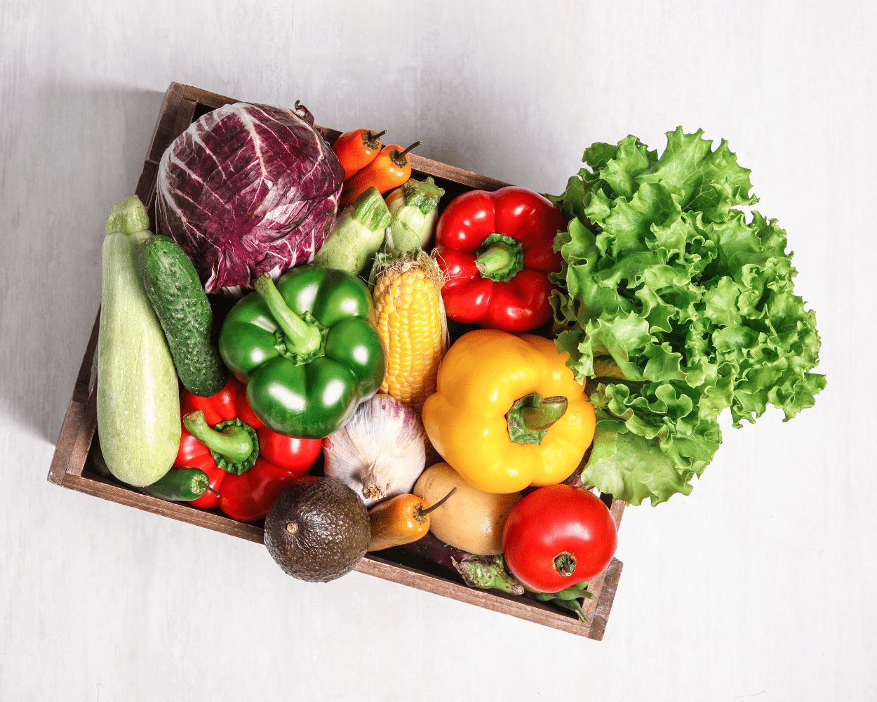 An image of a delivery box of fresh produce on light background.